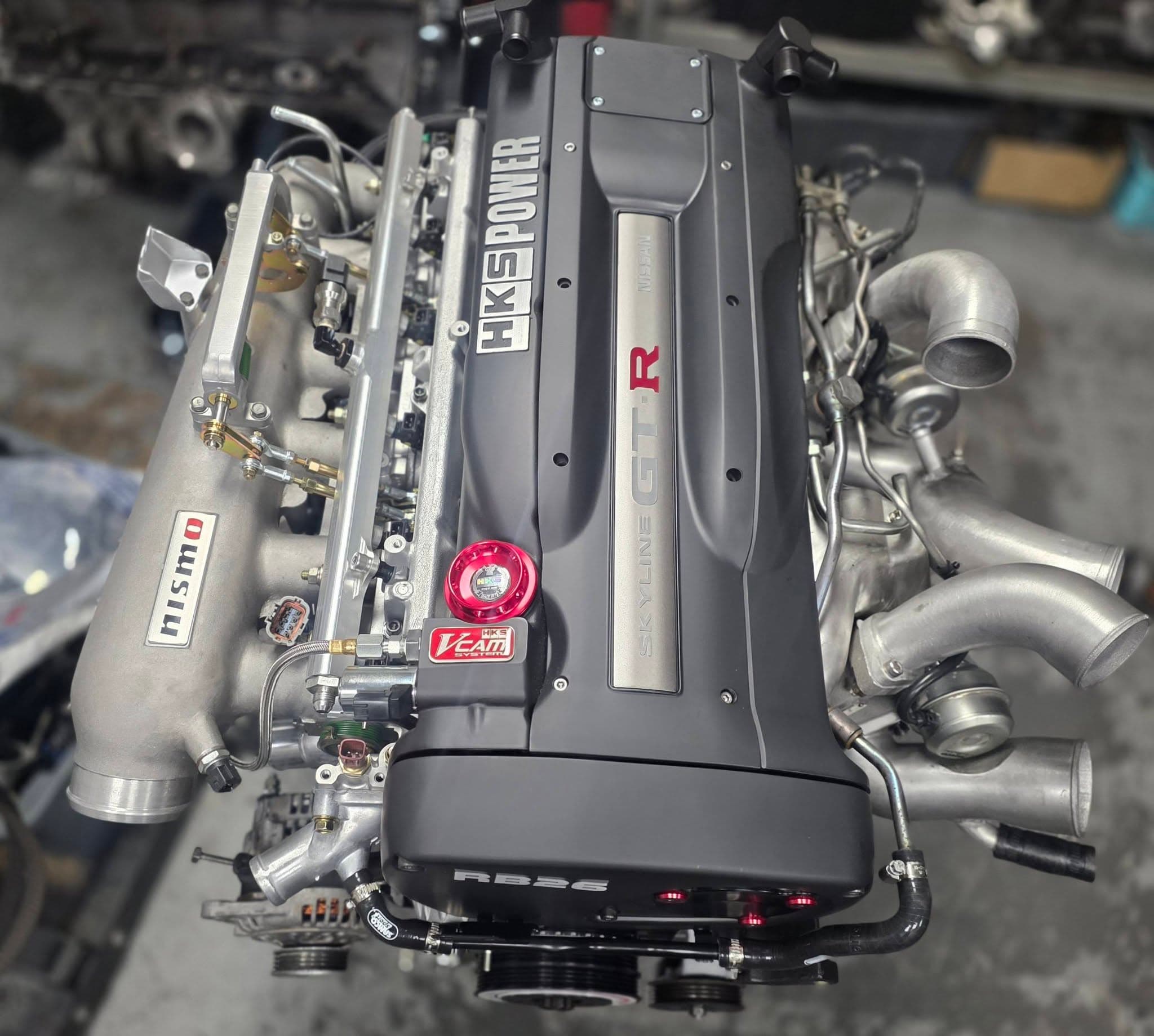 A built Nissan RB26 GT-R engine with HKS V-Cam, Nismo plenum and twin turbos, ready to go in